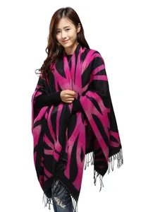 Close-up of pink and black geometric pattern on shawl with edge fringe details