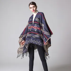 Detail of the navy blue ethnic poncho with geometric patterns and fringe tassels