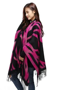 Detail of pink and black geometric pattern cashmere-like shawl with fringed edges
