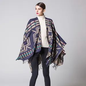 Detail of ethnic geometric knit shawl with navy base, colorful patterns and black fringe