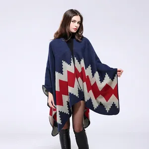 Aztec patterned knitted poncho wrap with blue and red geometric zigzag design for women