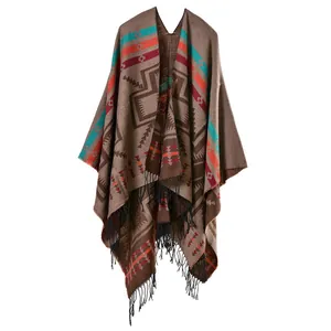 Close-up of bohemian geometric knit shawl with colorful patterns and black fringe trim