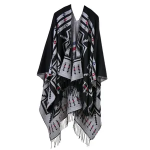 Ethnic knit shawl cloak with geometric patterns and tassel hem in black and gray tones
