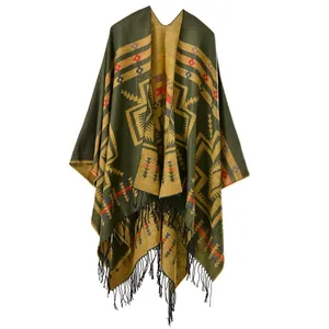 Close-up of geometric ethnic patterns and thick black tassel fringe on the shawl