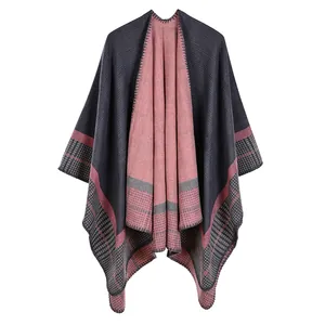 Women's pink and dark grey striped knit shawl cloak with classic plaid edge detail