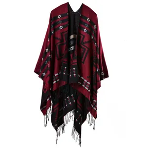Detail of bohemian red knit shawl with ethnic geometric patterns and black fringe tassels