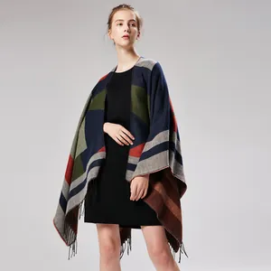 Close-up of geometric color-block knitted shawl with intricate fringe hem detail