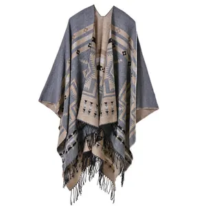Detail view of ethnic style fringe and geometric patterns on a thick split shawl