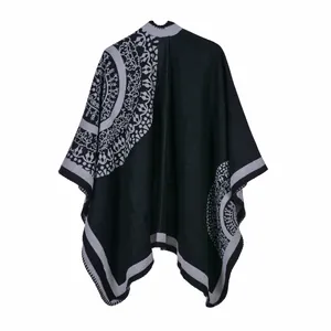 Detail of classic black and grey shawl with mandala patterns and knitted texture
