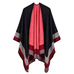 Close-up showing the soft knit texture and striped geometric patterns of this poncho
