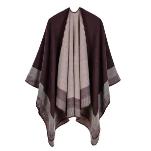 Close-up of geometric color block poncho with detailed blanket stitching and knit texture