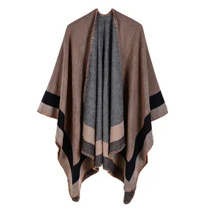 Detail view of coffee and grey knit poncho with black stripes and fine edge stitching