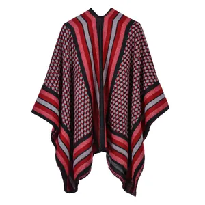 Detailed knit texture of red and black striped split poncho shawl with geometric patterns