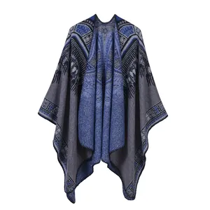 Close-up of knit shawl showing intricate blue and grey geometric bohemian patterns