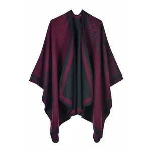 Close-up of ethnic totem pattern on wine red and black faux cashmere shawl