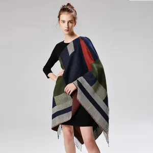 Detailed view of jacquard geometric pattern and fringe trim on the split women's poncho shawl