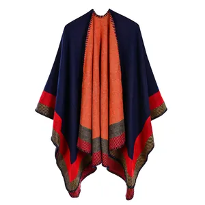 Thick geometric knit shawl with orange and navy double-sided contrast design