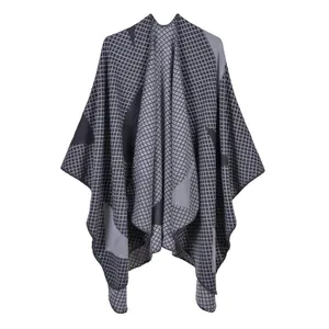 Detailed view of grey checkered knit shawl cape with fine overlock stitched edges