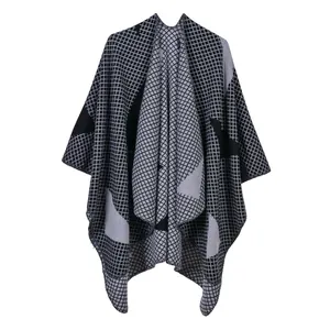 Detail of soft knit texture on a black and grey striped women shawl with grid pattern
