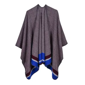 Detail of red and grey houndstooth shawl featuring vibrant color-block striped hems