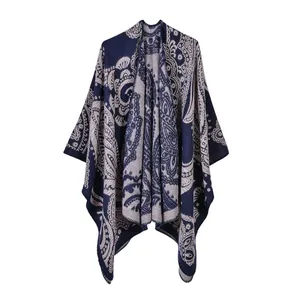 Dettaglio del motivo paisley boho su uno scialle in maglia spessa blu scuro e poncho