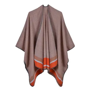 Detail of grey houndstooth shawl with orange striped hem and fine lock-edge stitching