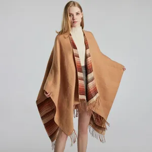Close-up of classic plaid pattern and fringe detail on warm thick cashmere-like shawl