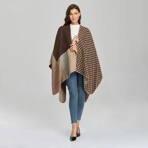 Detail view of stylish multi-color patchwork knit poncho wrap with classic plaid patterns