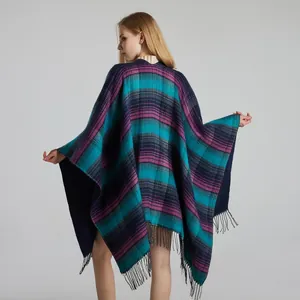 Detailed close-up of blue and purple tartan plaid shawl with soft grey tassel fringe