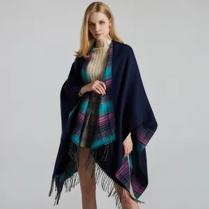 Detail of navy blue shawl featuring colorful plaid lining and thick wool-like tassels