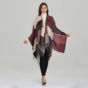Detail of vintage multicolored plaid shawl with fringe tassels and warm knit texture