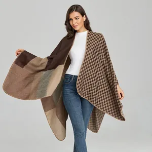 Detailed view of women's warm knit poncho featuring earthy patchwork and checkered patterns