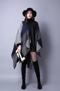 Modern jacquard knit poncho shawl with geometric color blocking and wool blend texture