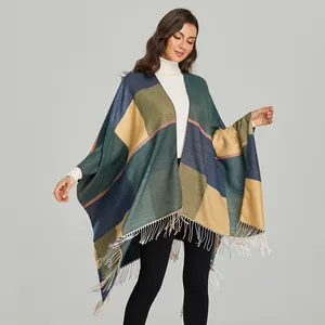 Detail of multi-color colorblock knit shawl featuring a vintage jacquard pattern and fringes