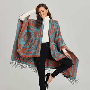 Bohemian paisley poncho wrap with black tassels and vibrant geometric ethnic patterns