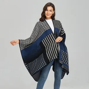 Women's double-sided knit shawl cape with geometric patterns and fringe detail