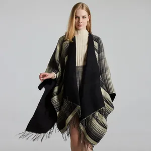 Close-up of soft plaid shawl featuring classic tassels and thick cashmere-like texture