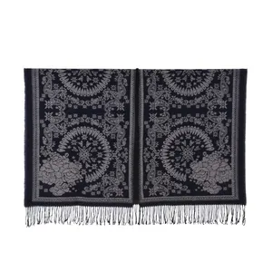 Close-up of vintage paisley pattern and floral details on women's winter shawl fringe