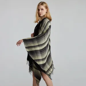 Detail of classic plaid shawl texture with tassels and soft knit fabric weave