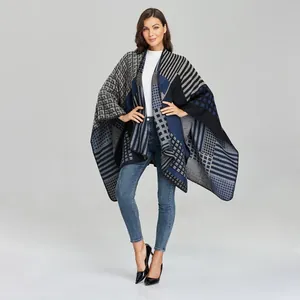Detail view of women's knitted shawl wrap with geometric color block patterns
