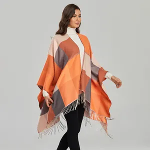 Detailed view of women's shawl featuring geometric color blocks and fringe edges