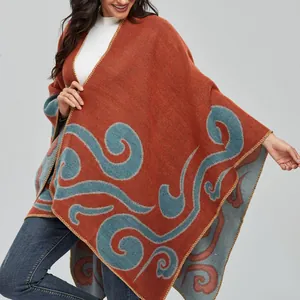 Women's warm bohemian knit shawl in orange with blue scroll patterns for winter