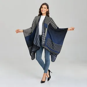 Detailed knit texture of a color-block geometric shawl with striped jacquard patterns