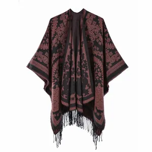 Detail view of ethnic paisley knit shawl with soft fringes and bohemian pattern
