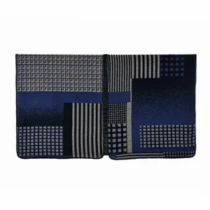 Detailed view of geometric color-block knit poncho with neat overlock stitching edges