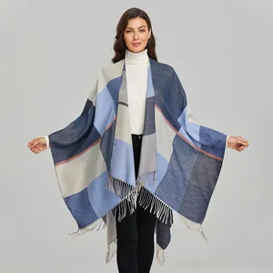 Close-up showing the soft texture and tassel detail of this blue plaid shawl cloak