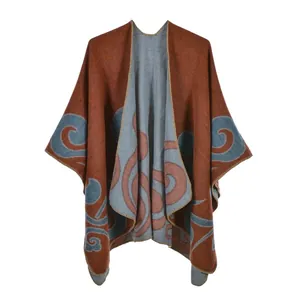 Reversible knit shawl cloak with large retro patterns in brick red and grey blue