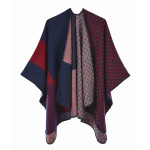 Close-up of split-front knit poncho with blue and red checkerboard pattern textures