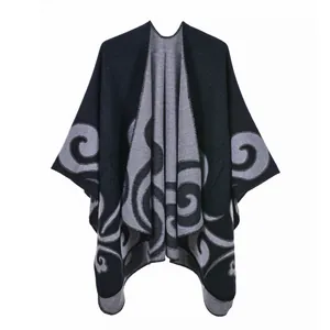 Detailed view of dark blue and grey cashmere shawl featuring elegant spiral knit patterns