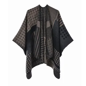 Detail of geometric pattern knit poncho with black and khaki checkerboard texture